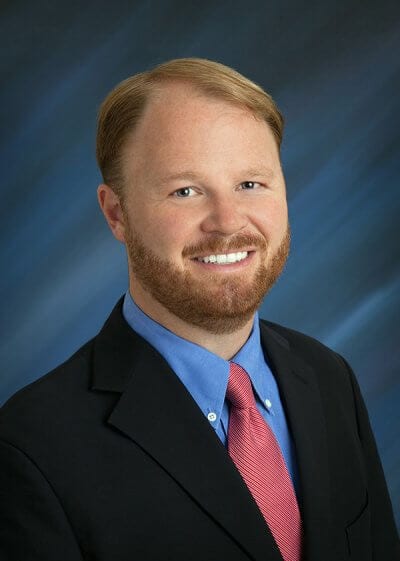 Man in suit smiling.