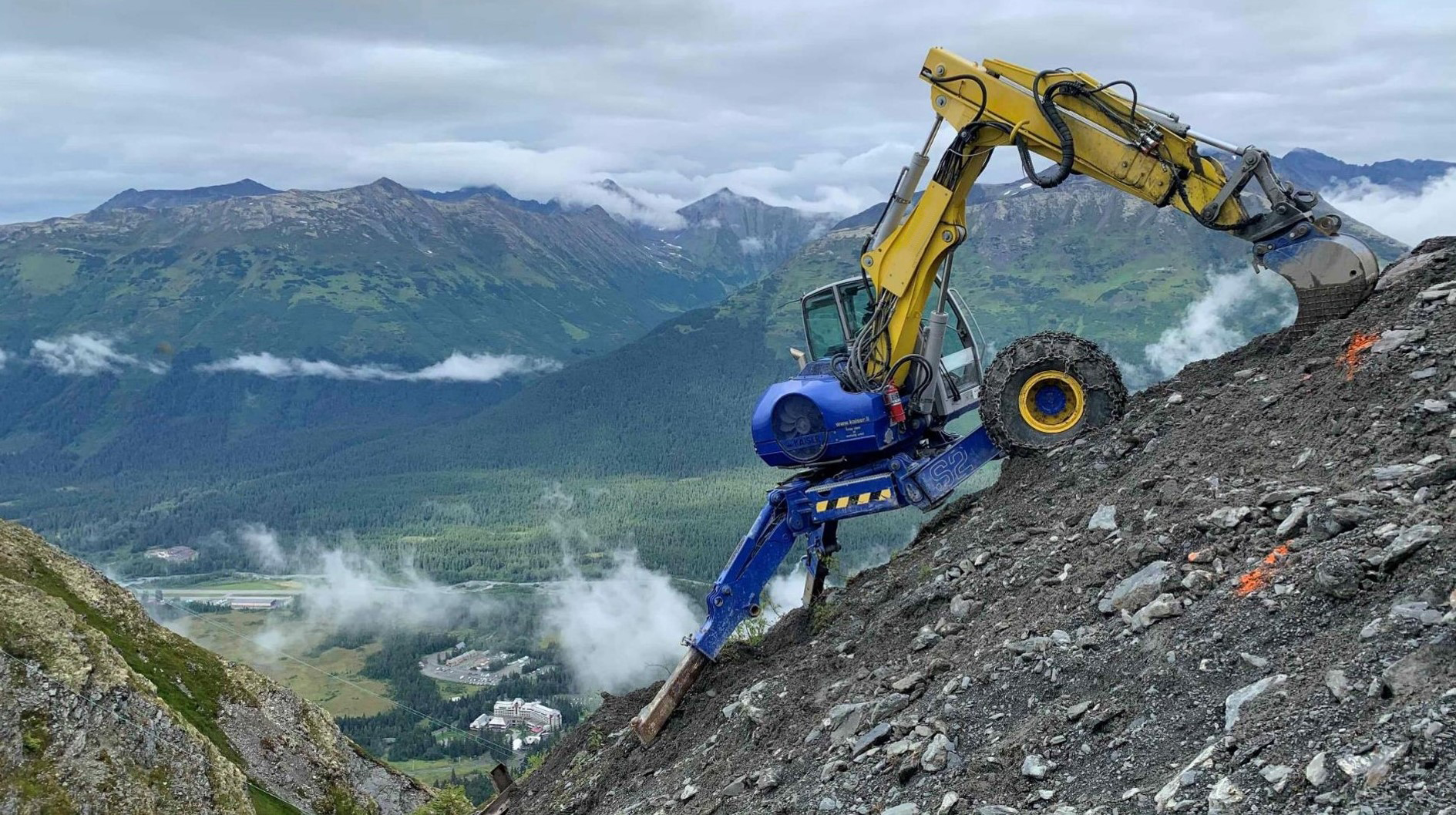 Spider excavator working on a steep mountainside.